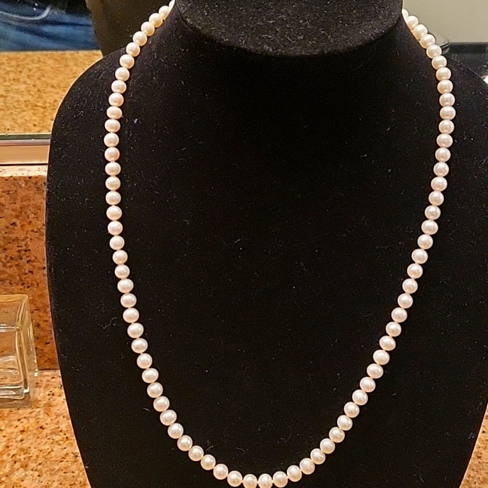 White 23 inch cultured pearl necklace with 14ct gold hook clasp.